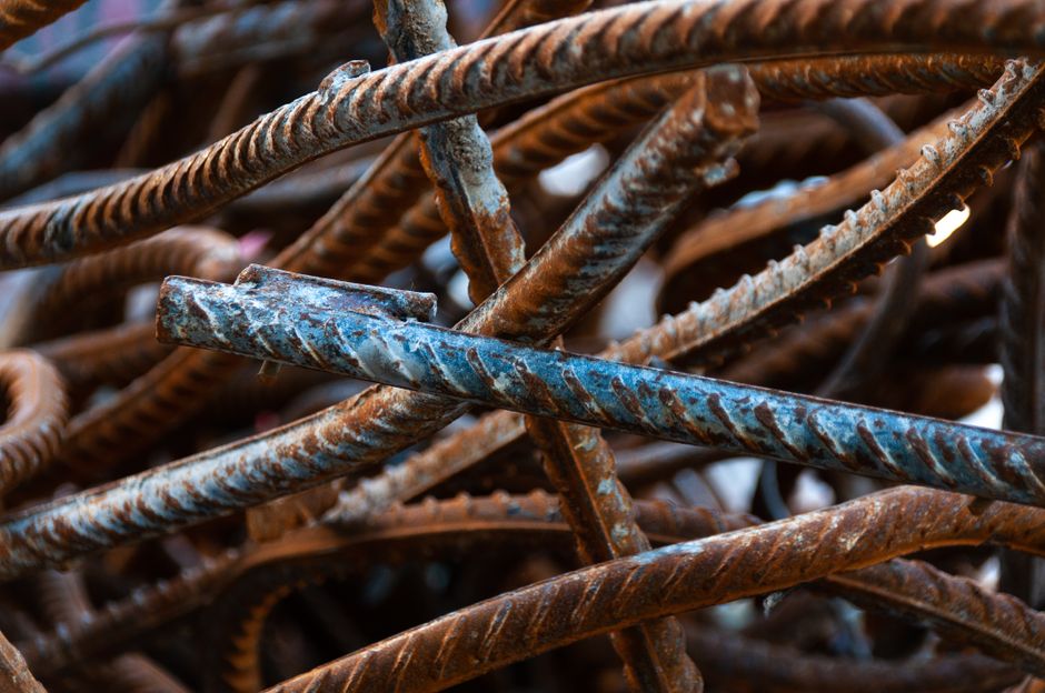 A detailed close-up of twisted, rusty iron rebar. Perfect for construction and industrial themes.